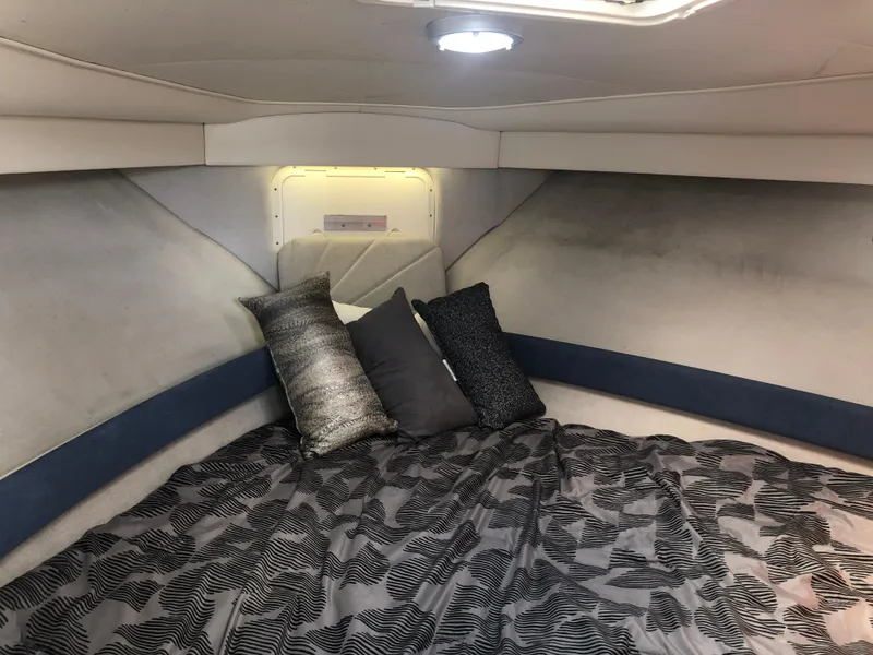 Slide: The Image of 1993 Carver 350 Aft Cabin interior with cozy bed and decorative pillows. - 19