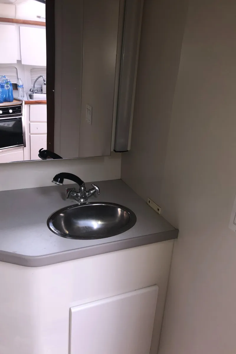 Slide: The Image of 1993 Carver 350 Aft Cabin bathroom sink with modern faucet and mirror. - 25