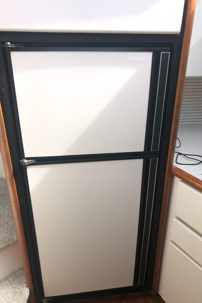 Slide: The Image of 1993 Carver 350 Aft Cabin refrigerator, dual-door design, compact and efficient for marine use. - 29
