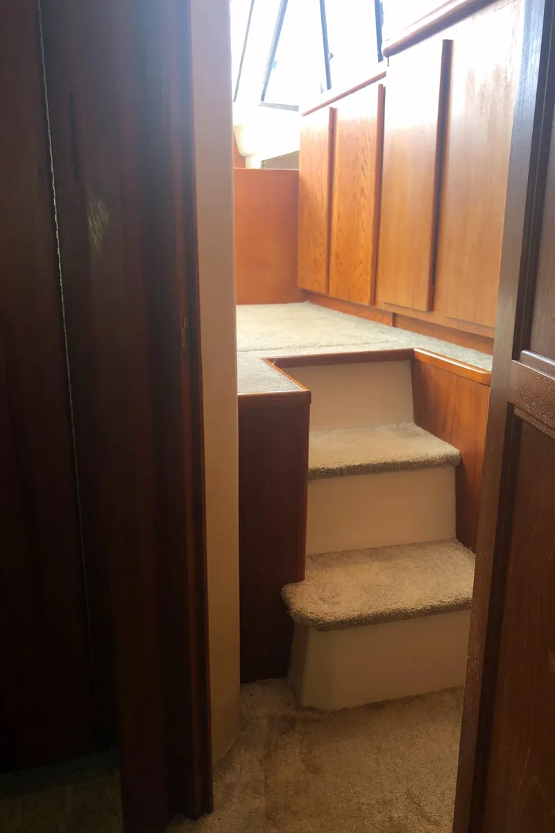 Slide: The Image of Interior stairs of 1993 Carver 350 Aft Cabin yacht with wooden paneling. - 31