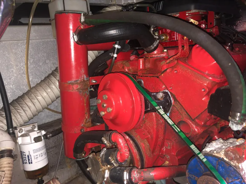 Slide: The Image of Engine compartment of a 1993 Carver 350 Aft Cabin boat, featuring red engine components. - 39