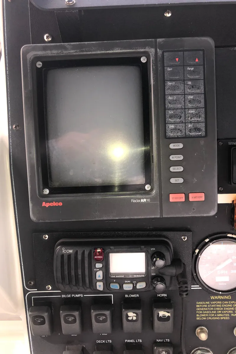 Slide: The Image of Control panel of a 1993 Carver 350 Aft Cabin boat with navigation and communication equipment. - 42