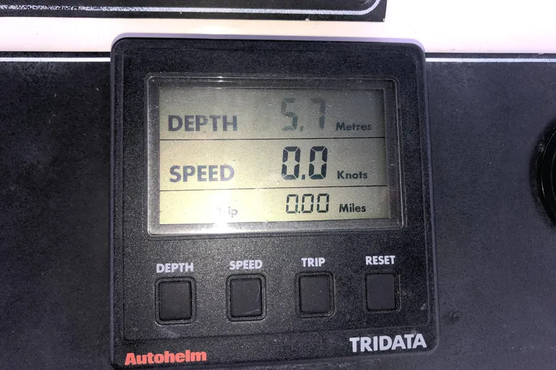 Slide: The Image of Autopilot display showing depth 5.7 meters, speed 0.0 knots on Carver 350 Aft Cabin. - 43