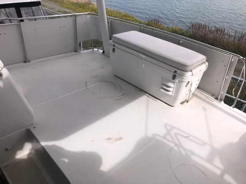 Slide: The Image of 1993 Carver 350 Aft Cabin deck with storage box, overlooking water. - 5