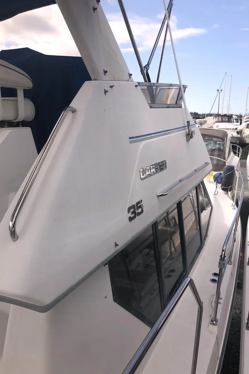 Slide: The Image of 1993 Carver 350 Aft Cabin yacht docked at marina, side view. - 6