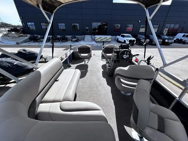 Slide: The Image of 2023 Sun Tracker BASS BUGGY® 18 DLX pontoon boat interior with seating and steering console. - 13