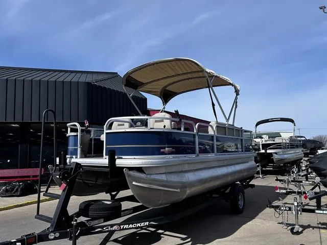 Slide: The Image of 2023 Sun Tracker BASS BUGGY® 18 DLX pontoon boat on trailer, outdoor display. - 7