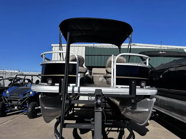 Slide: The Image of 2021 Sun Tracker BASS BUGGY® 18 DLX pontoon boat, docked, with seating and railing. - 11