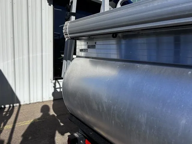 Slide: The Image of 2021 Sun Tracker BASS BUGGY® 18 DLX pontoon boat with 60 HP engine, docked outdoors. - 4