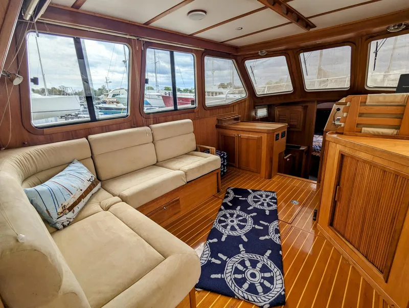 Slide: The Image of Interior of 2003 Sabre 36 Flybridge yacht with beige seating and nautical decor. - 10