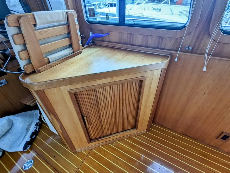 Slide: The Image of 2003 Sabre 36 Flybridge interior with wooden cabinetry and seating. - 11