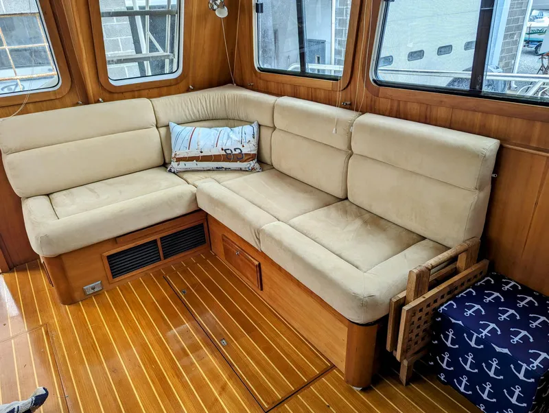 Slide: The Image of Interior of 2003 Sabre 36 Flybridge with beige seating and nautical decor. - 13