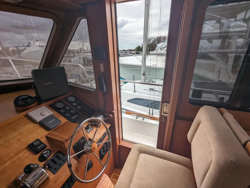 Slide: The Image of Interior view of 2003 Sabre 36 Flybridge yacht helm with steering wheel and controls. - 15