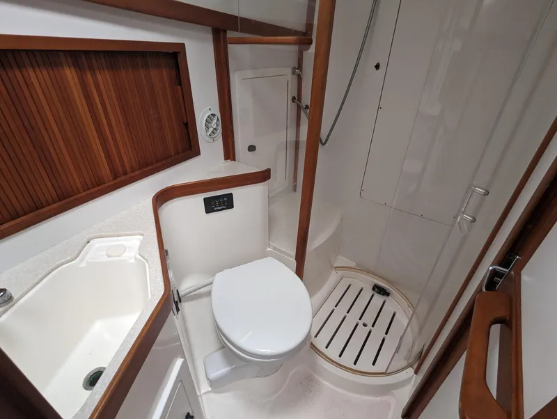 Slide: The Image of 2003 Sabre 36 Flybridge bathroom with shower, toilet, and sink. - 18