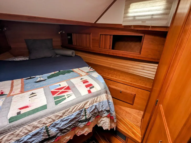 Slide: The Image of Cozy cabin interior of 2003 Sabre 36 Flybridge with nautical-themed bedding. - 27