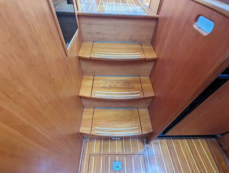 Slide: The Image of Wooden stairs inside 2003 Sabre 36 Flybridge yacht, featuring elegant design and craftsmanship. - 29