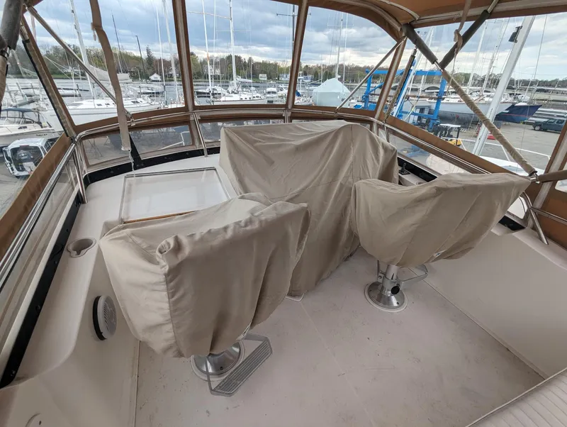 Slide: The Image of 2003 Sabre 36 Flybridge with covered seating, overlooking marina. - 32