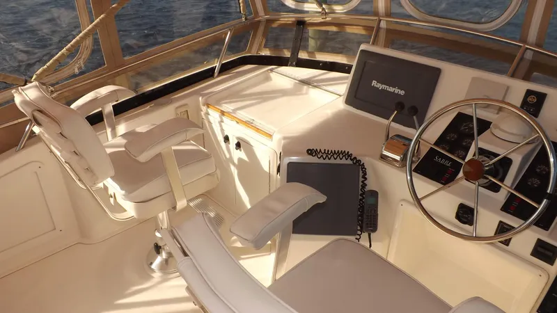 Slide: The Image of 2003 Sabre 36 Flybridge helm with steering wheel and navigation equipment. - 35