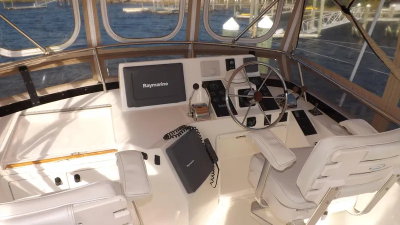 Slide: The Image of 2003 Sabre 36 Flybridge helm with Raymarine navigation system and dual captain chairs. - 36