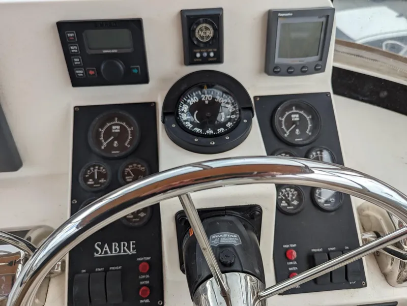 Slide: The Image of Control panel of 2003 Sabre 36 Flybridge with gauges and steering wheel. - 39