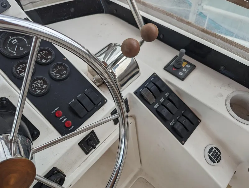 Slide: The Image of 2003 Sabre 36 Flybridge helm with steering wheel, gauges, and control panel. - 40