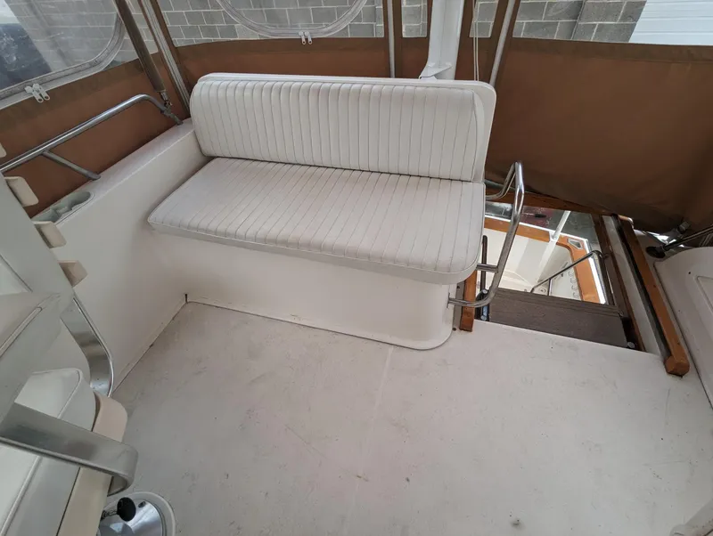 Slide: The Image of 2003 Sabre 36 Flybridge interior with white seating and brown accents. - 42