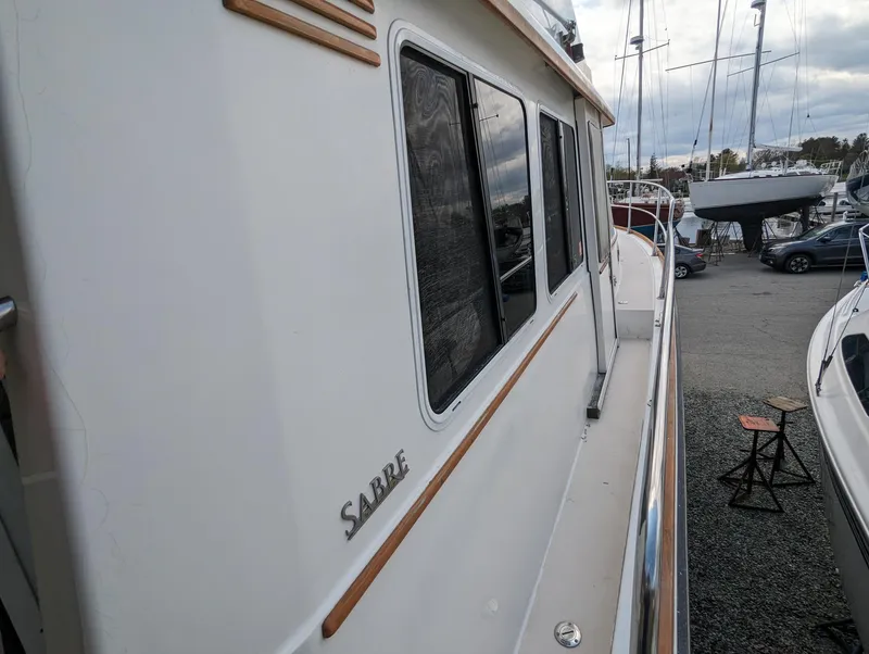 Slide: The Image of 2003 Sabre 36 Flybridge yacht side view at marina. - 43