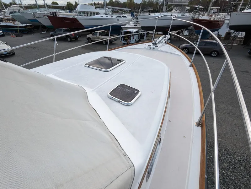 Slide: The Image of 2003 Sabre 36 Flybridge yacht deck with hatches, docked among other boats. - 44