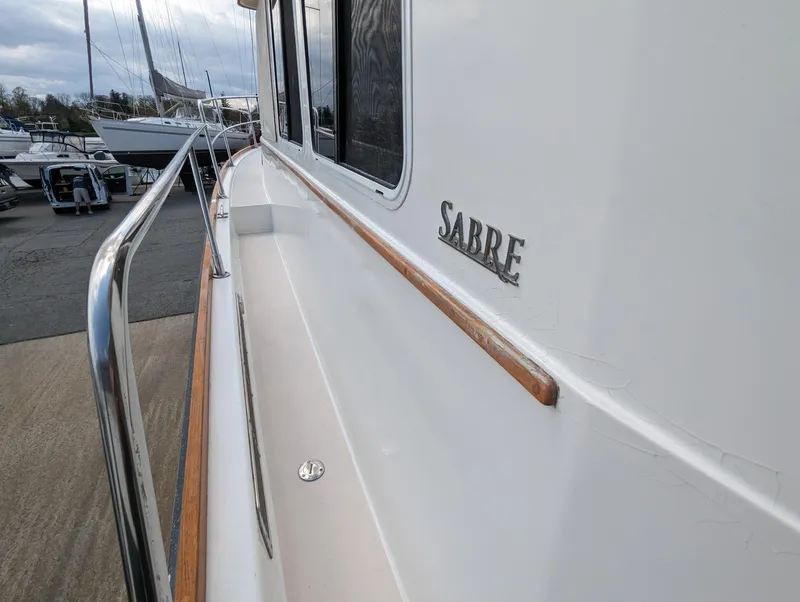 Slide: The Image of 2003 Sabre 36 Flybridge yacht side view with railing and logo. - 47