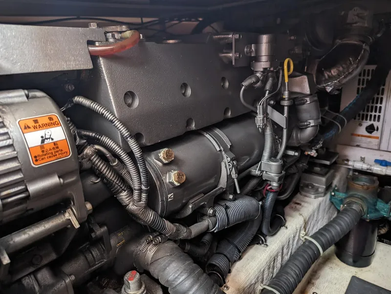 Slide: The Image of Engine compartment of a 2003 Sabre 36 Flybridge boat, showcasing mechanical components. - 48