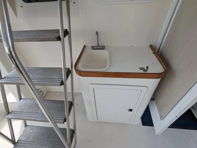Slide: The Image of 2003 Sabre 36 Flybridge interior with sink and ladder. - 5