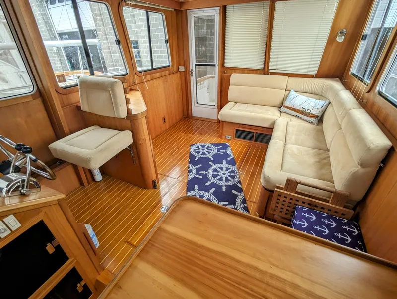 Slide: The Image of Interior of 2003 Sabre 36 Flybridge with beige seating and nautical-themed decor. - 7
