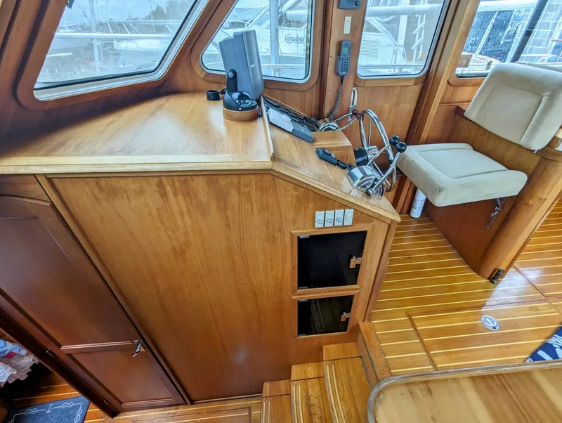 Slide: The Image of 2003 Sabre 36 Flybridge interior with wooden helm, controls, and seating. - 8