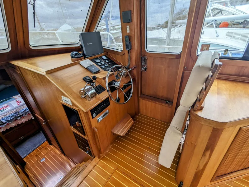Slide: The Image of 2003 Sabre 36 Flybridge helm with wooden interior and navigation equipment. - 9