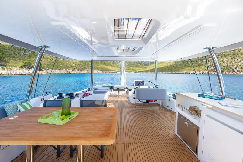 Slide: The Image of Luxurious Lagoon 60 yacht interior, 2025 model, featuring spacious deck and scenic ocean view. - 20