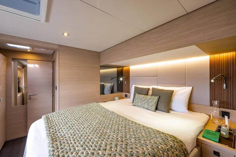 Slide: The Image of Luxurious bedroom interior of 2025 Lagoon 60 yacht with modern design and cozy bedding. - 30