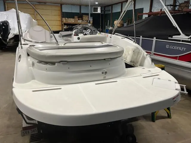 Slide: The Image of 2017 Hurricane SS202 boat in storage, showcasing spacious deck and seating area. - 16