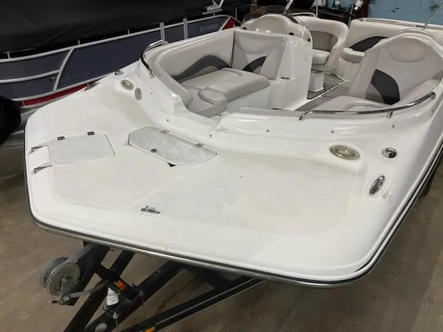 Slide: The Image of 2017 Hurricane SS202 boat with spacious seating and sleek design in a showroom. - 19