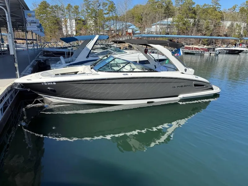 The Image of 2018 Regal 2800 Bowrider boat docked on a calm lake. - 1