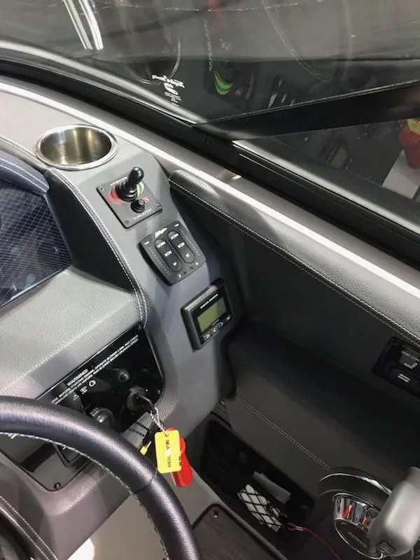 Slide: The Image of 2018 Regal 2800 Bowrider dashboard with controls and cup holder. - 14