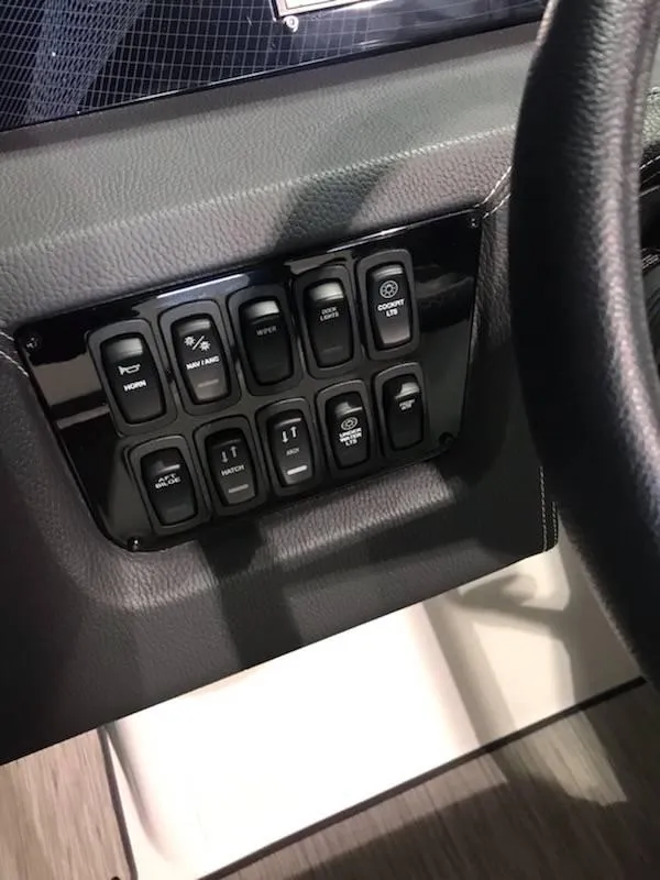 Slide: The Image of Control panel of a 2018 Regal 2800 Bowrider boat with multiple switches. - 15