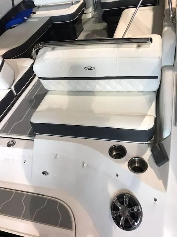 Slide: The Image of 2018 Regal 2800 Bowrider interior with white seating and cup holders. - 16