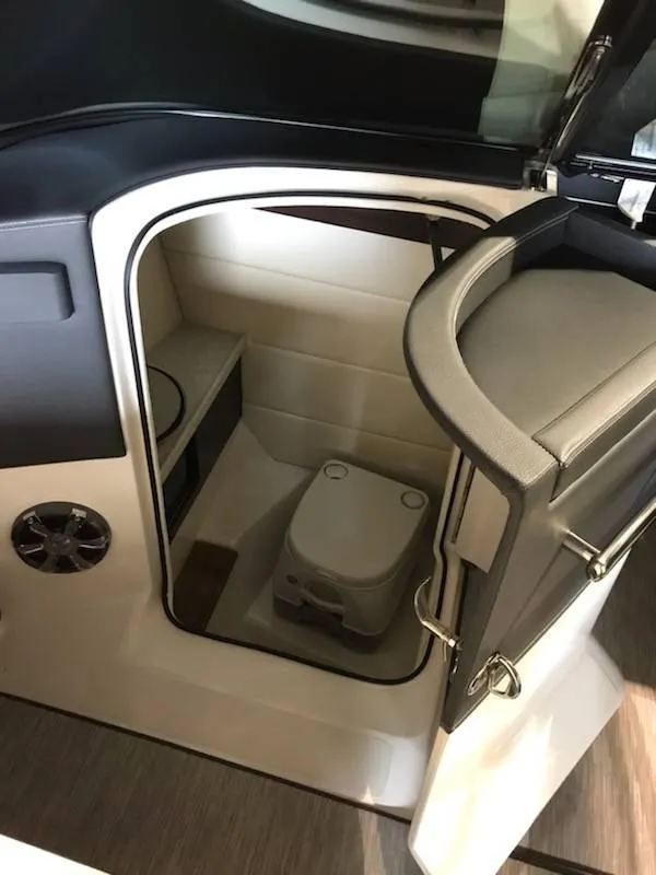 Slide: The Image of 2018 Regal 2800 Bowrider interior with compact marine toilet and storage space. - 7