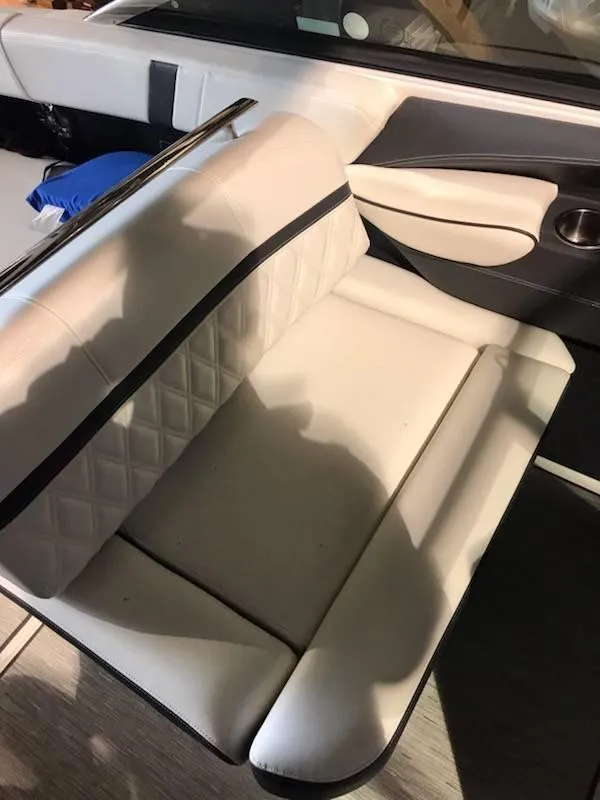 Slide: The Image of 2018 Regal 2800 Bowrider interior with white leather seating and modern design. - 8