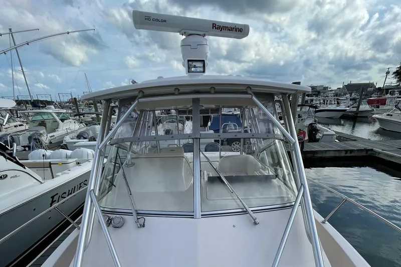 Slide: The Image of 2005 Grady-White Marlin 300 boat docked at marina under cloudy sky. - 10