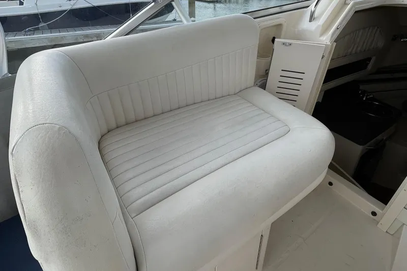 Slide: The Image of 2005 Grady-White Marlin 300 boat interior with white cushioned seating. - 11