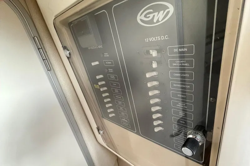 Slide: The Image of Control panel of a 2005 Grady-White Marlin 300 boat, featuring 12-volt DC switches. - 14