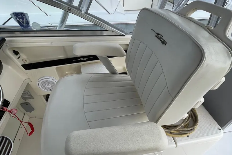 Slide: The Image of Captain's chair on 2005 Grady-White Marlin 300 boat, featuring white upholstery and armrests. - 15