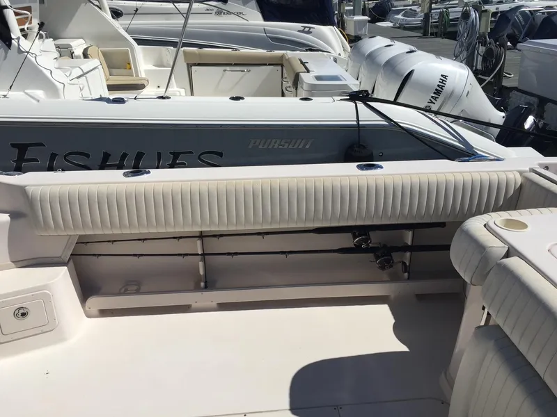 Slide: The Image of 2005 Grady-White Marlin 300 boat interior with fishing rod holders and Yamaha engines. - 3