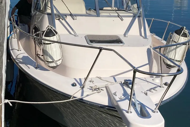 Slide: The Image of 2005 Grady-White Marlin 300 boat docked, featuring sleek design and sturdy railings. - 4